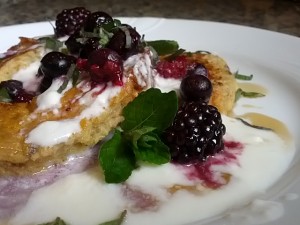 French Toast cut like a doughnut, with berries, kefir, maple syrup & mint.
